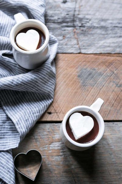 A photo of Hot Chocolate topped with Whipped Cream Melting Heart