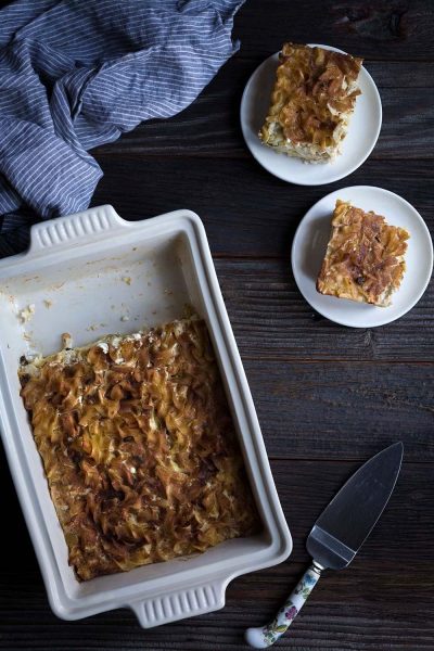 This sweet Apple Noodle Kugel recipe is perfect for celebrating Jewish holidays including Chanukah and Passover! Sour cream, cottage cheese, and a cinnamon-sugar topping help make this a perfect comfort food dish.