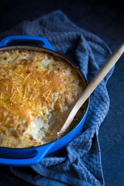 This Cheesy Potatoes Au Gratin recipe is perfect for celebrating the holidays with friends and family! Sharp cheddar cheese takes it to a whole new level.