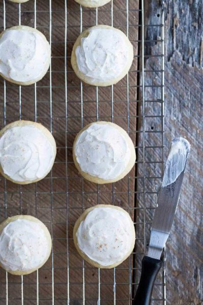 Frosted eggnog cookies on a cooling rack