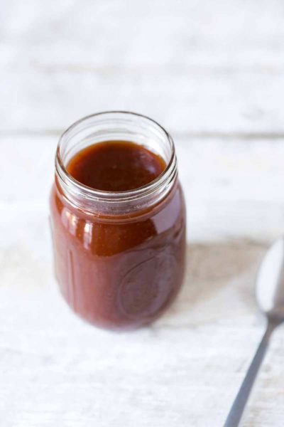 Homemade barbecue sauce recipe in mason jar with a spoon