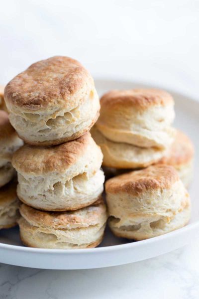A close up of mile high homemade biscuits prepared using buttermilk. Super light and fluffy.