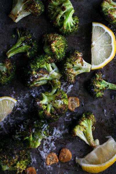 A close up of roasted broccoli with garlic and lemon