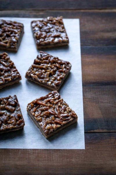 Pecan pie bars recipe laid out on a parchment sheet