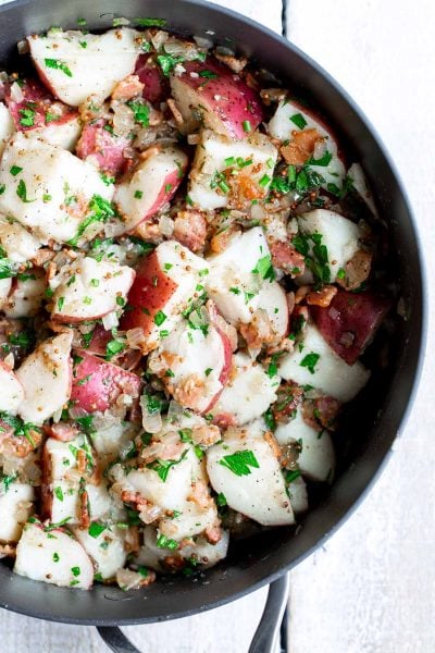 Closeup of German Potato Salad in a flat-sided skillet
