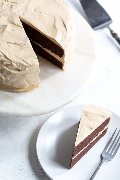 This chocolate peanut butter cake recipe is my new favorite. Two layers of moist, rich chocolate cake are frosted with a fluffy peanut butter meringue buttercream.