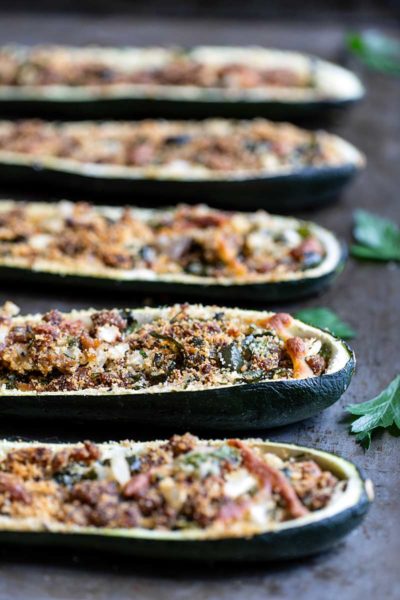 Side angle closeup of Italian sausage-stuffed zucchini boats recipe