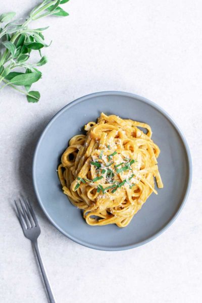 overhead image: plated dinner of pasta with pumpkin sauce