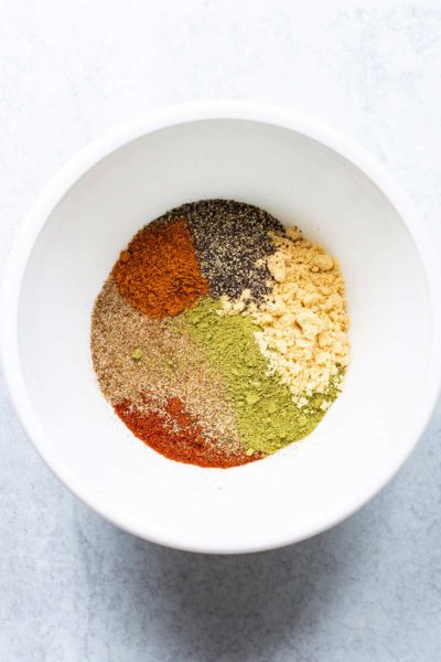Closeup of a bowl with unblended spices for homemade old bay seasoning