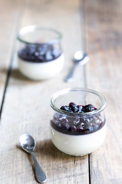 Buttermilk panna cotta recipe topped with blueberry compote, served in two mason jars