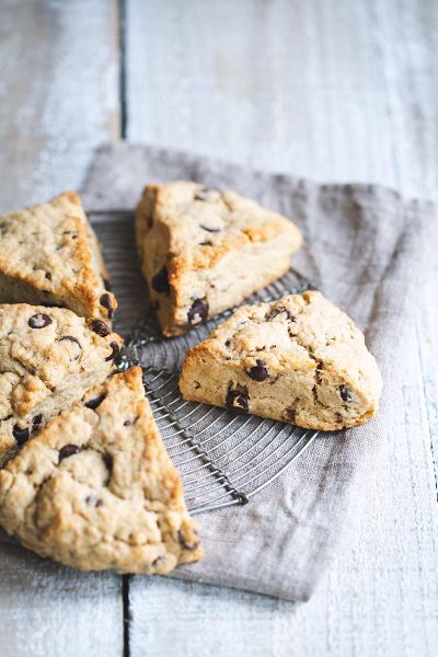 Chocolate chip scones on a round cooling rack and napkin